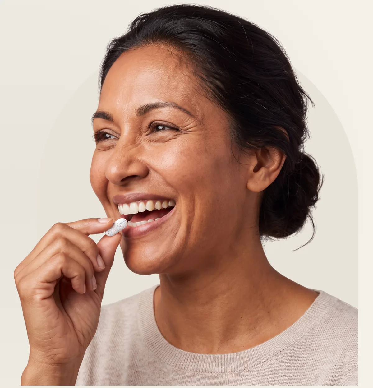 A woman taking a Retabolic Focus tablet in the morning